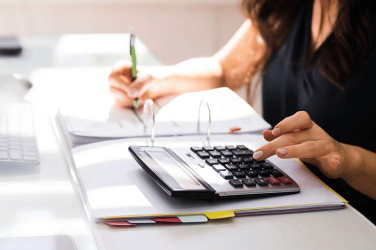 Chartered accountant hand calculating tax