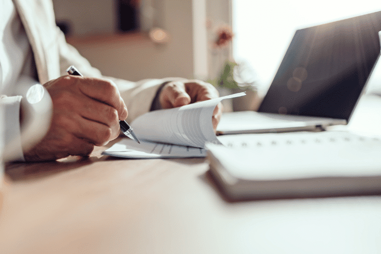 Close-up of a seller signing a contract